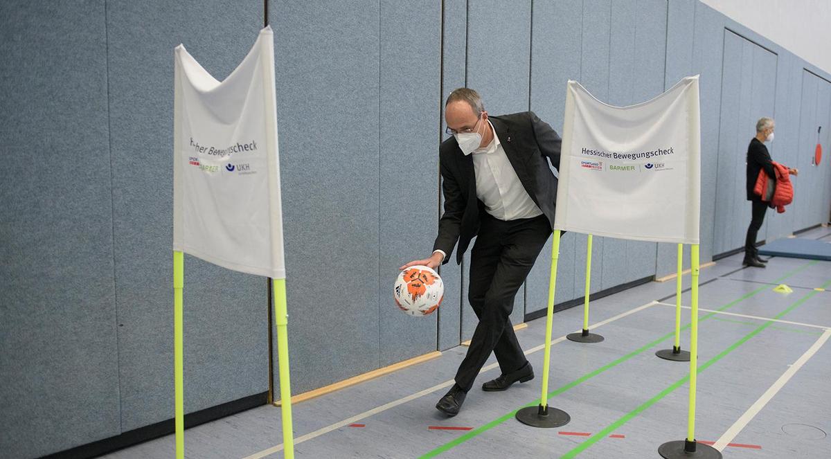 Öffnet eine Lightbox: Hessens Sportminister Peter Beuth dribbelt geschickt durch eine der 12 Parcours-Stationen.